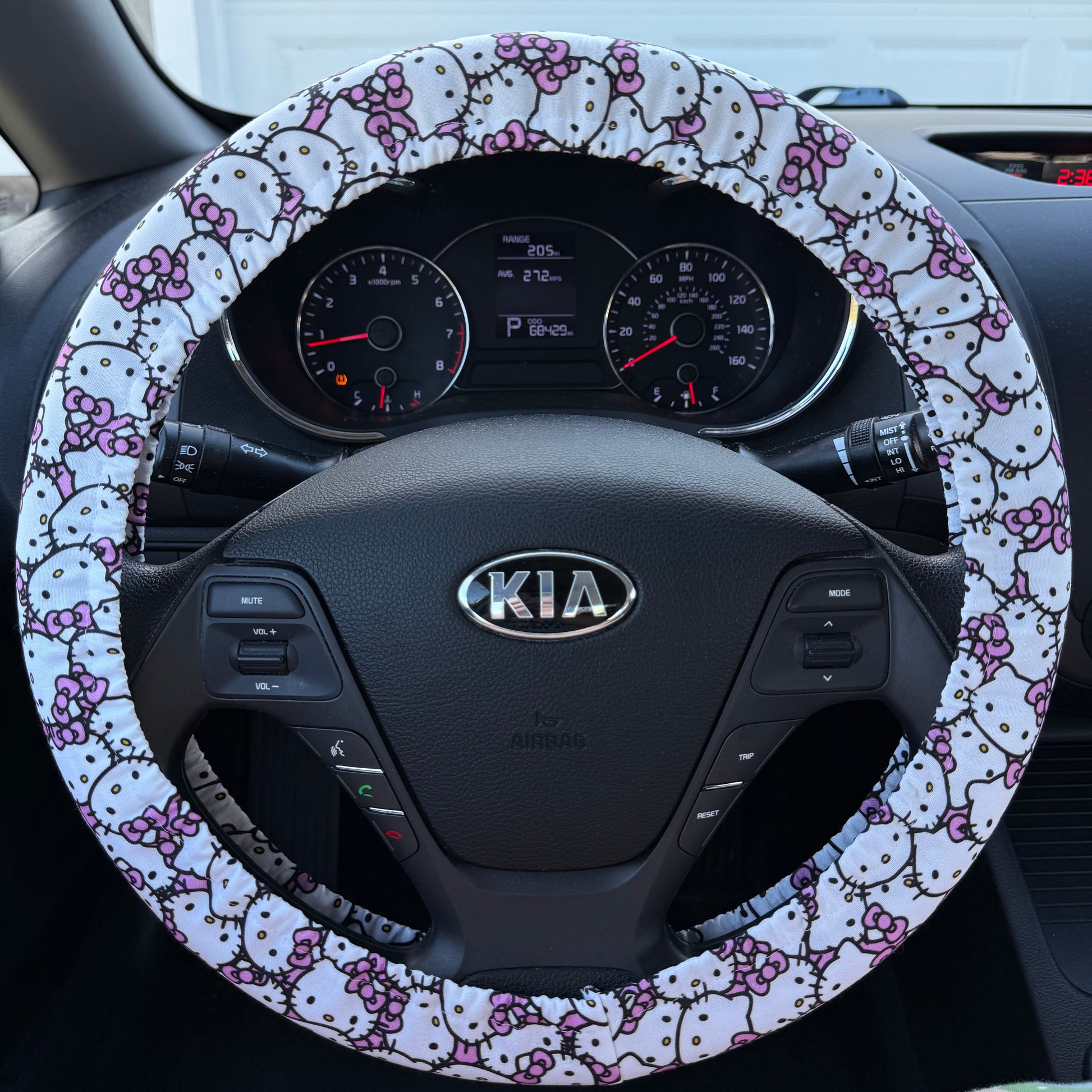 Steering wheel cover with Hello Kitty design on a Kia car steering wheel